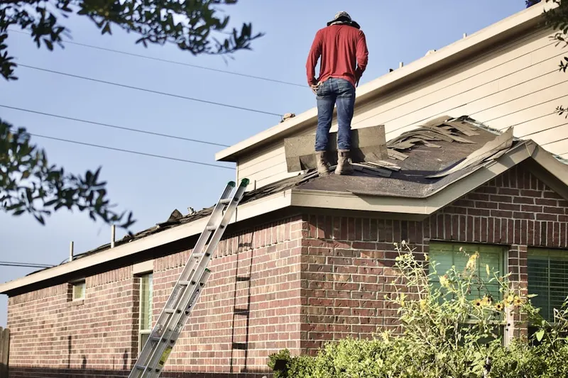 Professional roofer working on a residential roof in Unity